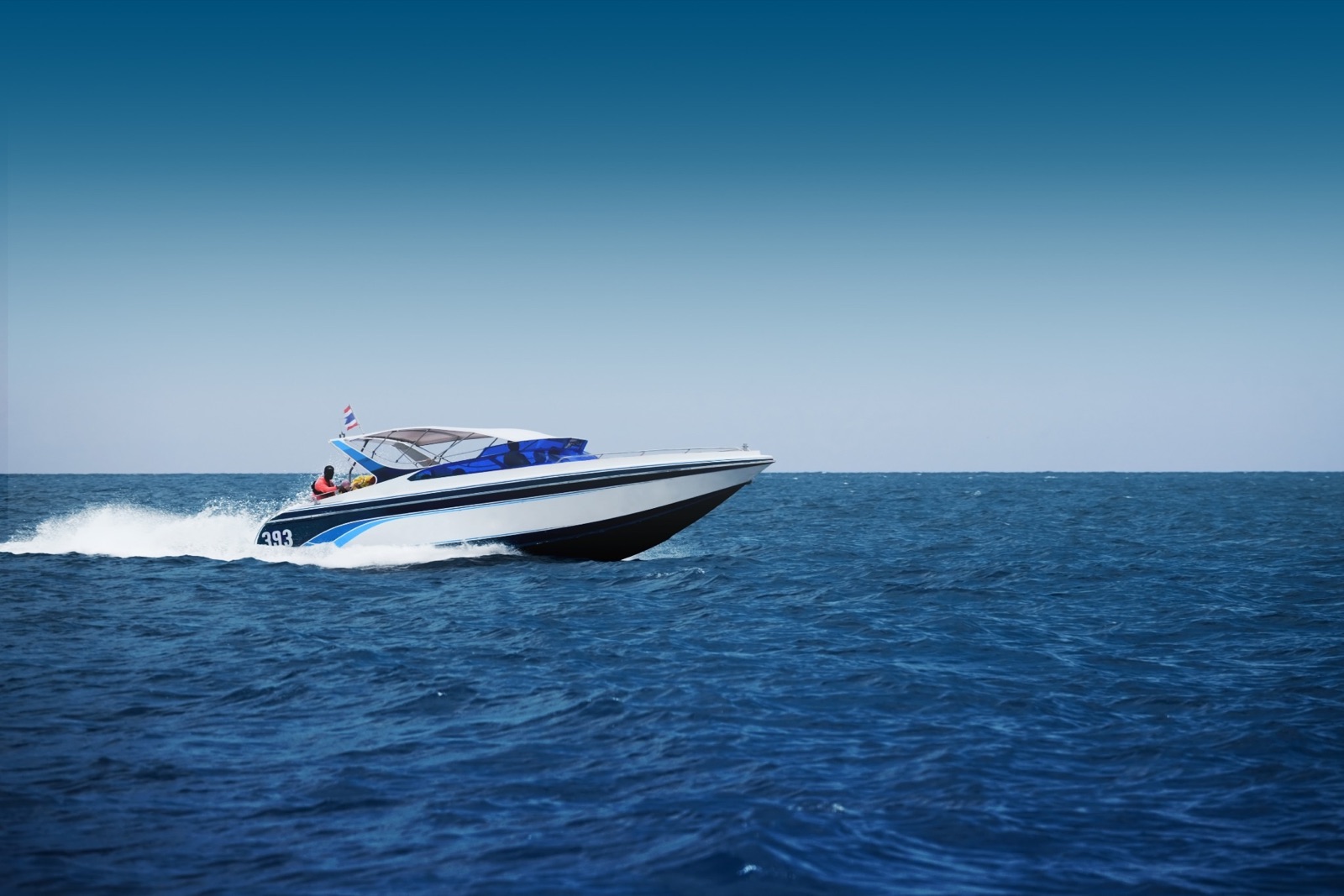 Speedboat crossing open water — boat loan refinancing